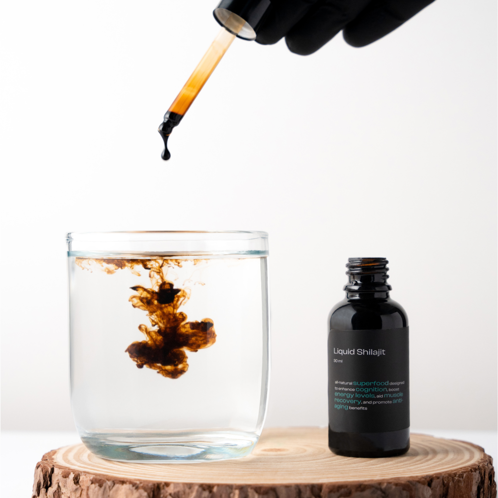 A drop of Liquid Shilajit is added to water, dissolving, with the bottle placed beside it, showcasing its cognitive and energy-boosting benefits.